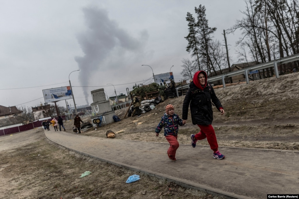 Banorët lokalë duke vrapuar për të gjetur strehim më 6 mars, teksa iknin nga qyteza e Irpinit, pas granatimeve të fuqishme në të vetmën rrugë largimi të përdorur nga banorët, ndërsa trupat ruse avanconin drejt kryeqytetit, Kievit.