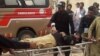 Police officers carry an injured colleague on a stretcher following a bomb blast in Sibi, a city in the southwestern Pakistani province of Balochistan, on March 8. 