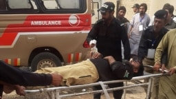 Police officers carry an injured colleague on a stretcher following a bomb blast in Sibi, a city in the southwestern Pakistani province of Balochistan, on March 8. 