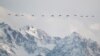 KAZAKHSTAN-ENVIRONMENT/ -- A flock of common cranes flies over the Ile Alatau mountains in Almaty Region, Kazakhstan March 7, 2022. REUTERS/Pavel Mikheyev