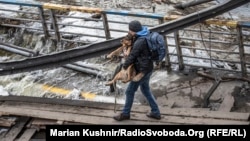 A man and his dog evacuate from Bucha in the Kyiv region on March 9. 