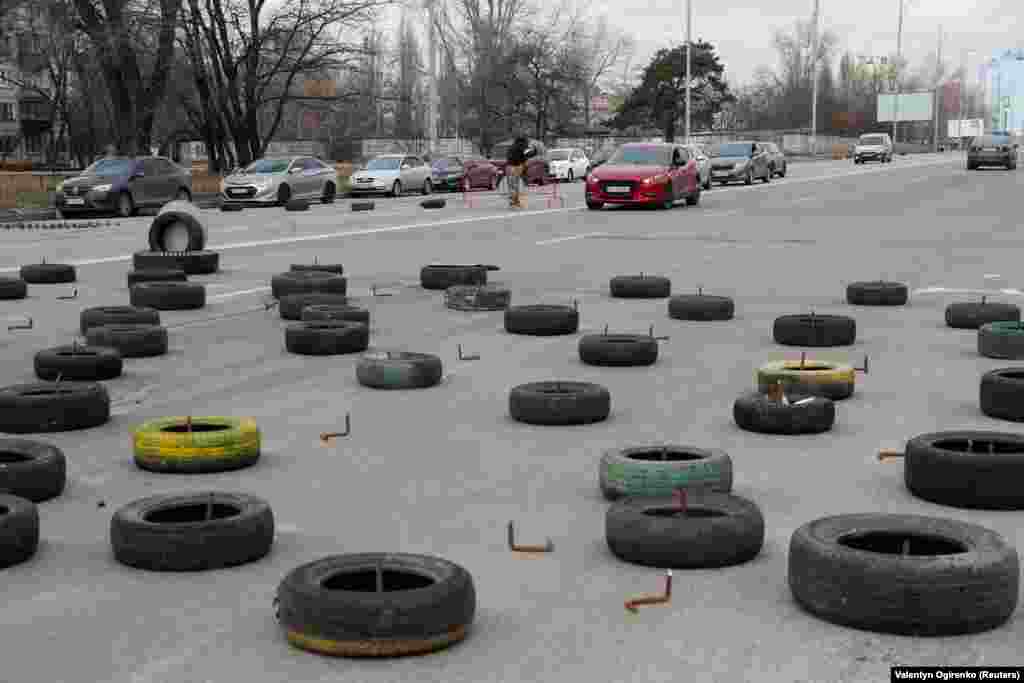 Twists of sharpened rebar and tires lie across a road at a checkpoint in Kyiv on March 6.&nbsp;