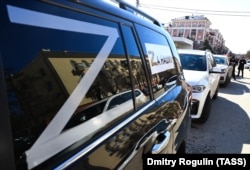 A column of vehicles parade through the streets of Volgograd to express support for Russian troops in Ukraine.