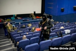 Members of the territorial defense rest at a movie theater in Kyiv on March 7, 2022.