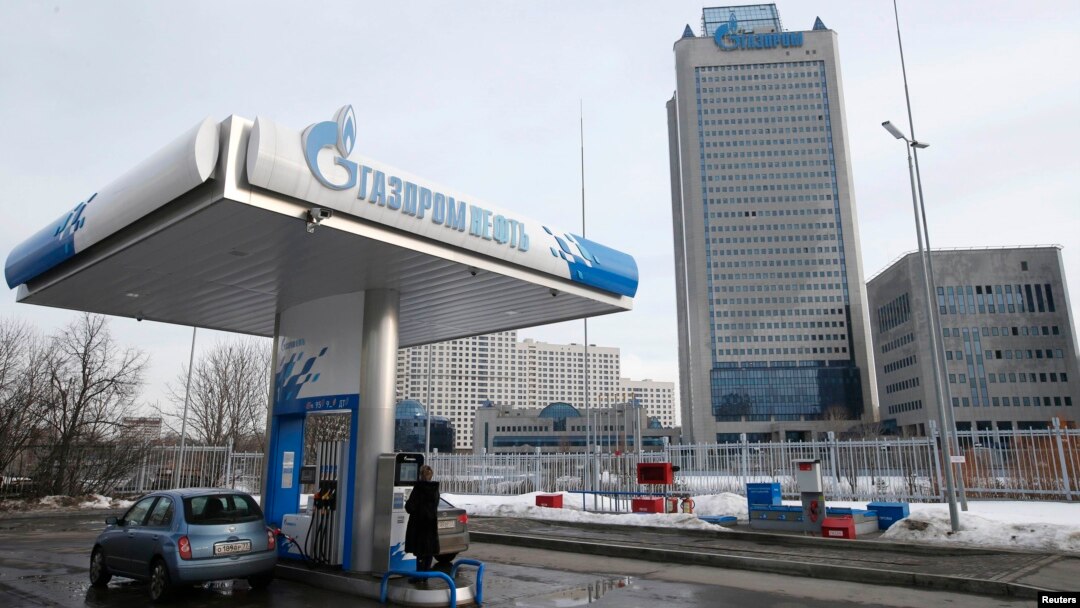 A Gazprom Neft gas station in Moscow with Gazprom headquarters in the background