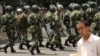 Chinese riot police patrol a street in Urumqi in China's Xinjiang Province. A new study finds that China is hunting Uyghurs and other Muslim minorities through a global dragnet that is increasingly relying on cooperation with governments in the Middle East and South and Central Asia. (file photo)