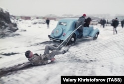 Oleg Kulik (sliding in the foreground) during a performance called Russian Safari in Moscow in 1995.