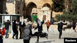 Palestinian protesters clash with Israeli security forces at the compound that houses Al-Aqsa Mosque, known to Muslims as Noble Sanctuary and to Jews as Temple Mount, in Jerusalem's Old City on April 22.
