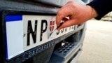 Kosovo: In Merdare border crossing between Kosovo and Serbia, drivers are putting stickers to their car plates. 22 April 2022