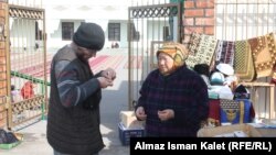 A trader outside a mosque in Bishkek