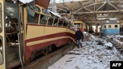 A resident examines a destroyed tram depot in Kharkiv on March 12.