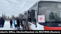 Buses wait during evacuations out of Sumy on March 8.