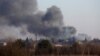 Smoke rises from a factory building near the airport in Lviv after a reported missile strikes on March 18. 