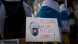 Lithuania Russia Ukraine War/ Russians with the Russian anti-war flags wrapped around them, take part in a protest against the Russian invasion of Ukraine in front of the Russian embassy in Vilnius, Lithuania, Saturday, March 12, 2022. 