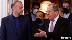 Russian Foreign Minister Sergei Lavrov (right) and Iranian Foreign Minister Hossein Amir-Abdollahian enter a hall during a meeting in Moscow in March 15.