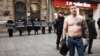 Serbia - Belgrade - A man with Ratko Mladic tattoo on chests standing near protest against Russian aggression on Ukraine organized by Women In Black