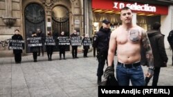 Serbia - Belgrade - A man with Ratko Mladic tattoo on chests standing near protest against Russian aggression on Ukraine organized by Women In Black