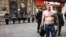 Serbia - Belgrade - A man with Ratko Mladic tattoo on chests standing near protest against Russian aggression on Ukraine organized by Women In Black