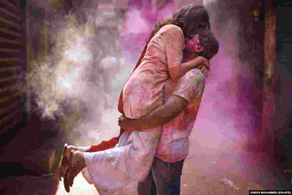 An Indian couple stained with colored powder enjoys a loving moment during Holi festival celebrations in Chennai.&nbsp;Holi, also known as the Festival Of Colors, is an ancient Indian Hindu festival symbolizing the victory of good over evil and marking the arrival of spring.