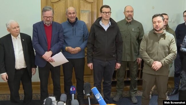 The Czech Republic's Petr Fiala (2nd left), Slovenia's Janez Jansa (3rd left), Poland's Mateusz Morawiecki (4th left) look on as Ukraine's Volodymyr Zelenskiy speaks to the press after a meeting in Kyiv on March 15.