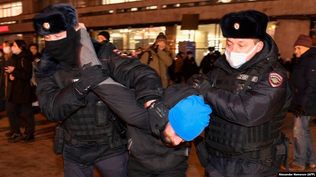 Police detain a demonstrator during a protest against Russia's invasion of Ukraine in Moscow on February 24.