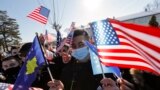 KOSOVO -- Kosovo Albanians wave U.S. and Kosovar national flags in the village of Bibaj, January 20, 2021