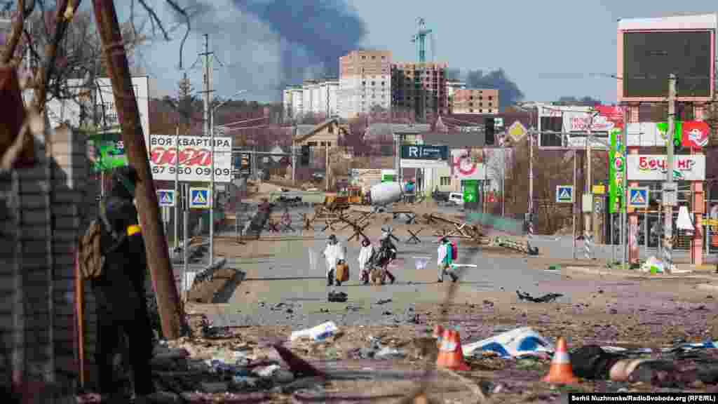 The consequences of Russia&#39;s attack on Irpin, near Kyiv, on March 11.&nbsp;(Serhii Nuzhnenko, RFE/RL) Nuzhnenko wrote: &quot;The border between death and life. On the horizon is the burning, smoking, occupied [city of] Bucha. Trapped civilians trying to flee the fighting come out wrapped in all white, holding white flags. Another soldier remarks, &#39;Everybody comes out in white, and those who want to go back to Bucha -- the Russians will kill them.&#39;&quot;