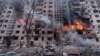Rescuers work next to a residential building damaged by shelling in Kyiv on March 14. 
