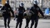 Russian police officers detain an anti-war protester in central Moscow on March 13. 
