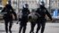 Russian police officers detain an anti-war protester in central Moscow on March 13. 