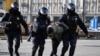 Сотрудники полиции задерживают мужчину во время акции протеста против военных действий России в Украине на Манежной площади в центре Москвы 13 марта 2022 года