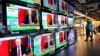 People stand by TV screens in Hong Kong broadcasting the news that Russian troops have launched an attack on Ukraine on February 24.