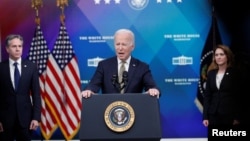 Flanked by Secretary of State Antony Blinken and Deputy Secretary of Defense Kathleen Hicks, U.S. President Joe Biden speaks about assistance the U.S. government is providing to Ukraine on March 16. 