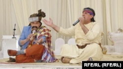 Two musicians perform a "music-less song" at a wedding party in Herat Province.