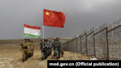 Frontier-defense troops of China and Tajikistan conduct a joint patrol along the Chinese-Tajik border in 2017.