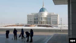 Работники убирают площадь перед главной резиденцией президента Казахстана в Астане. 