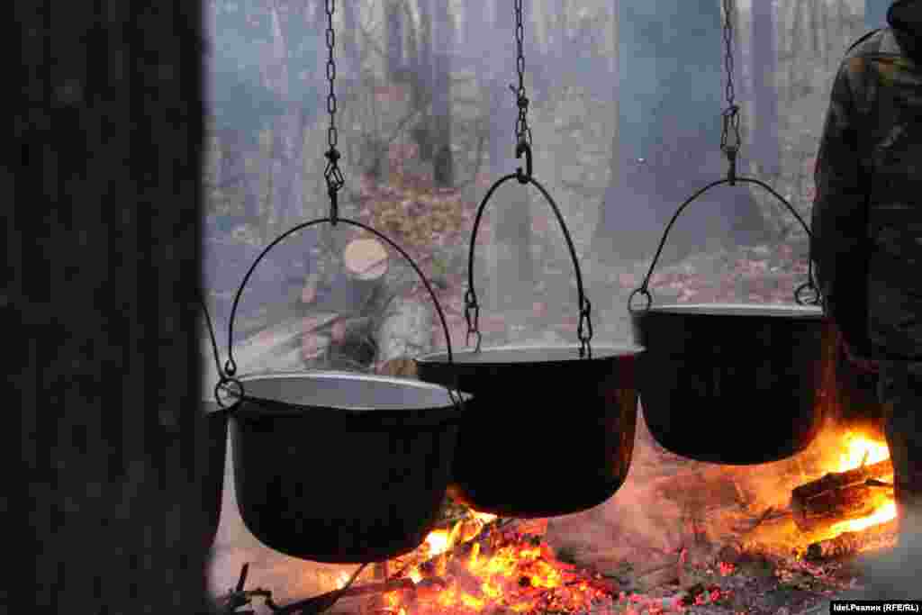 Pots of boiling meat after several animals were slaughtered near the grove.&nbsp;