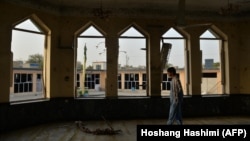A man inspects damage at the Gozar-e Sayed Abad Mosque a day after a suicide bombing in Kunduz on October 9. 