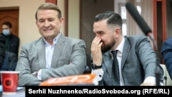 Viktor Medvedchuk (left) at his court hearing in Kyiv on October 12. 