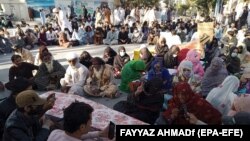 Relatives bring the bodies of victims to protest in front of the Chief Minister House in Quetta on October 13 after two children were killed in a bomb explosion two days earlier. 