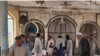 People view the damage inside a mosque following a bombing in the northern province of Kunduz on October 8.