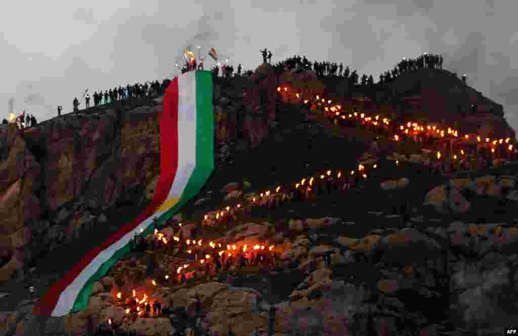 The torch-lit procession snakes up the mountainside.