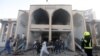 AFGHANISTAN -- Afghan men carry a victim from the site of a suicide attack followed by a clash between Afghan forces and insurgents after an attack on a Shi'ite Muslim mosque in Kabul, August 25, 2017