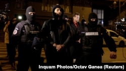 Andrew Tate and Tristan Tate are escorted by police officers in Bucharest on December 29.