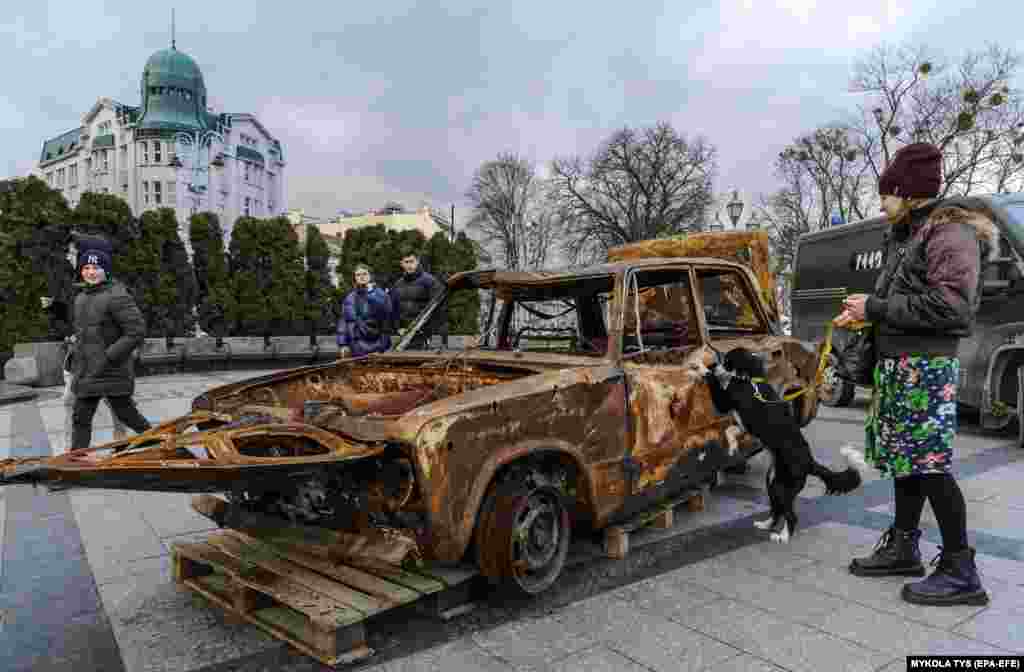 People look at destroyed cars that were brought by volunteers from the front line near Bakhmut to show the consequences of the war and raise funds for new vehicles for soldiers, in Lviv, Ukraine.