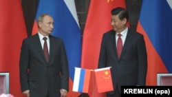 Russian President Vladimir Putin (left) and his Chinese counterpart, Xi Jinping, attend a ceremony in Shanghai before the signing of deals on gas and infrastructure projects in 2014.
