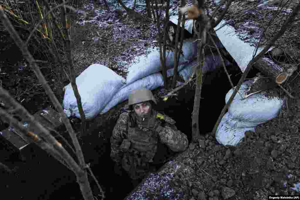 A Ukrainian soldier smokes a cigarette at his position near Bakhmut. Located astride two major crossroads, Bakhmut has been all but emptied of its 70,000 residents, as the city&#39;s buildings and homes have nearly all been destroyed.