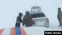 Rescue workers come to the aid of drivers stranded in Kazakhstan's Turkestan on January 3. 