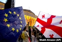 Demonstrators gather at a pro-EU and anti-government rally in front of the Georgian parliament in Tbilisi on July 3.