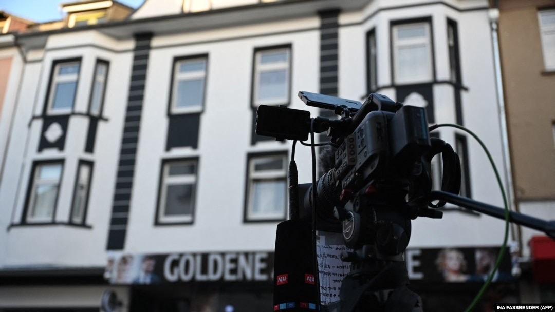 A news crew's camera is seen outside a house in Castrop-Rauxel, western Germany, where police arrested one of two Iranian brothers on suspicion of "having prepared a serious act of violence threatening the security of the state."